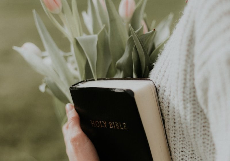 woman holding Holy Bible